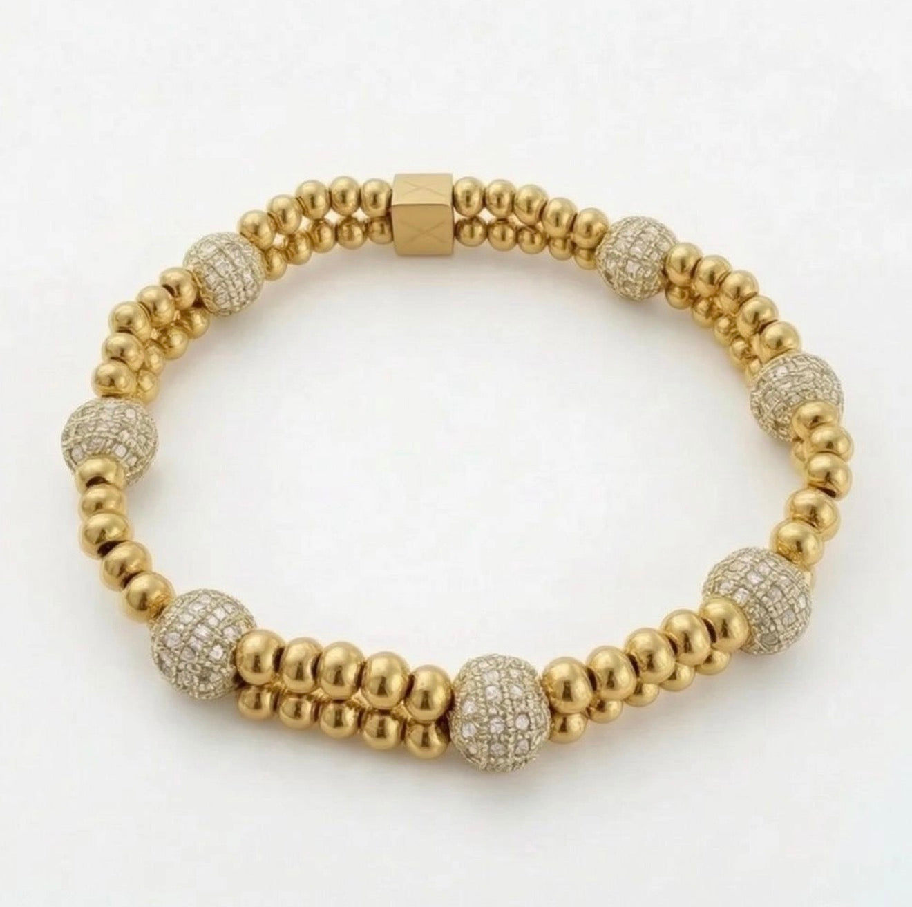 XX Élégance – Oro Celestia bracelet featuring polished gold beads and sparkling pavé crystal spheres, a handcrafted luxury jewelry piece by Atelier X.