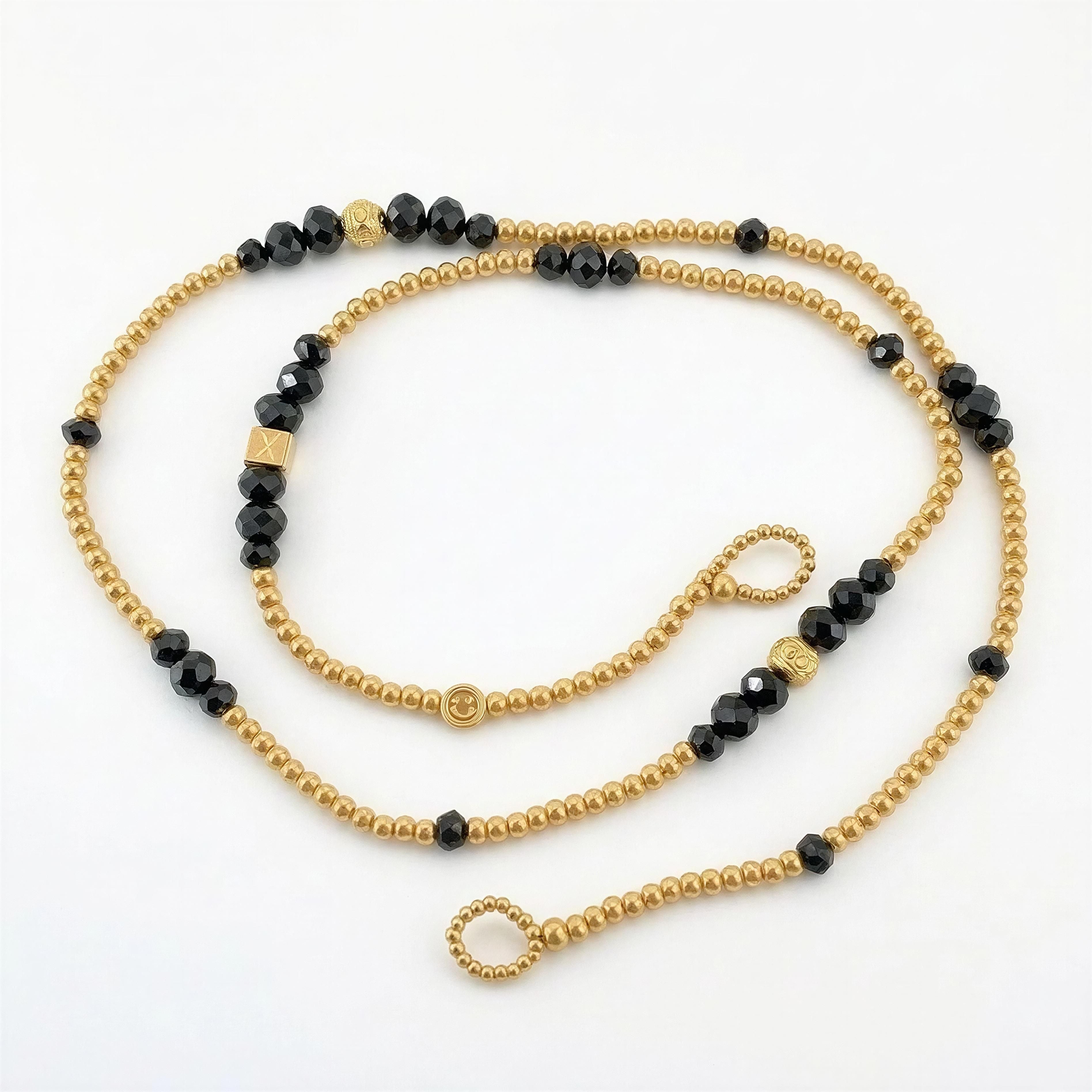 The Riviera Sunglass Chain — Limited Collection featuring a handcrafted design with gold and black beads, combining luxury and elegance for stylish eyewear.
