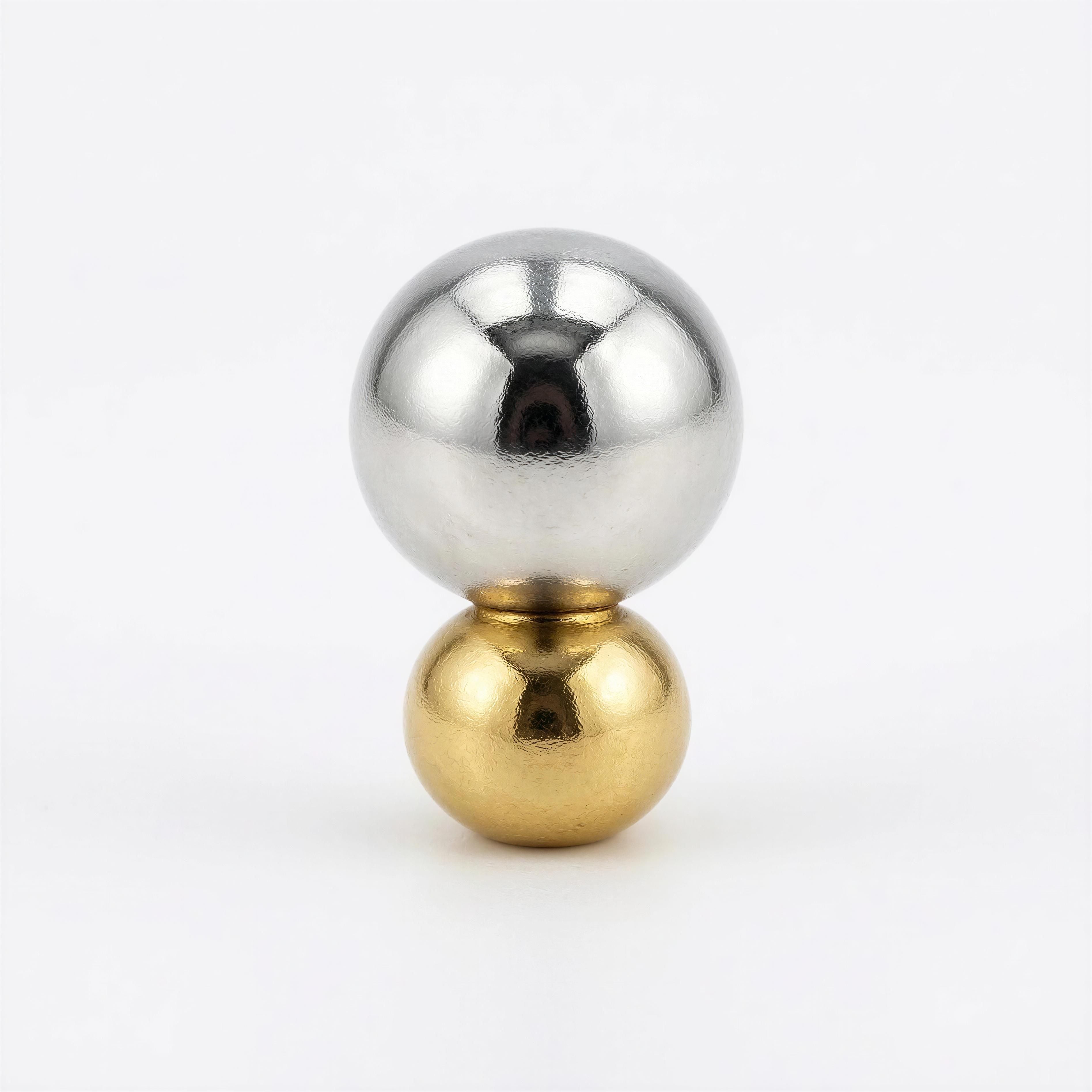 A polished silver sphere stacked atop a smaller gold sphere, showcasing minimalist luxury and precision craftsmanship from The Essential Collection - 6mm & 4mm.