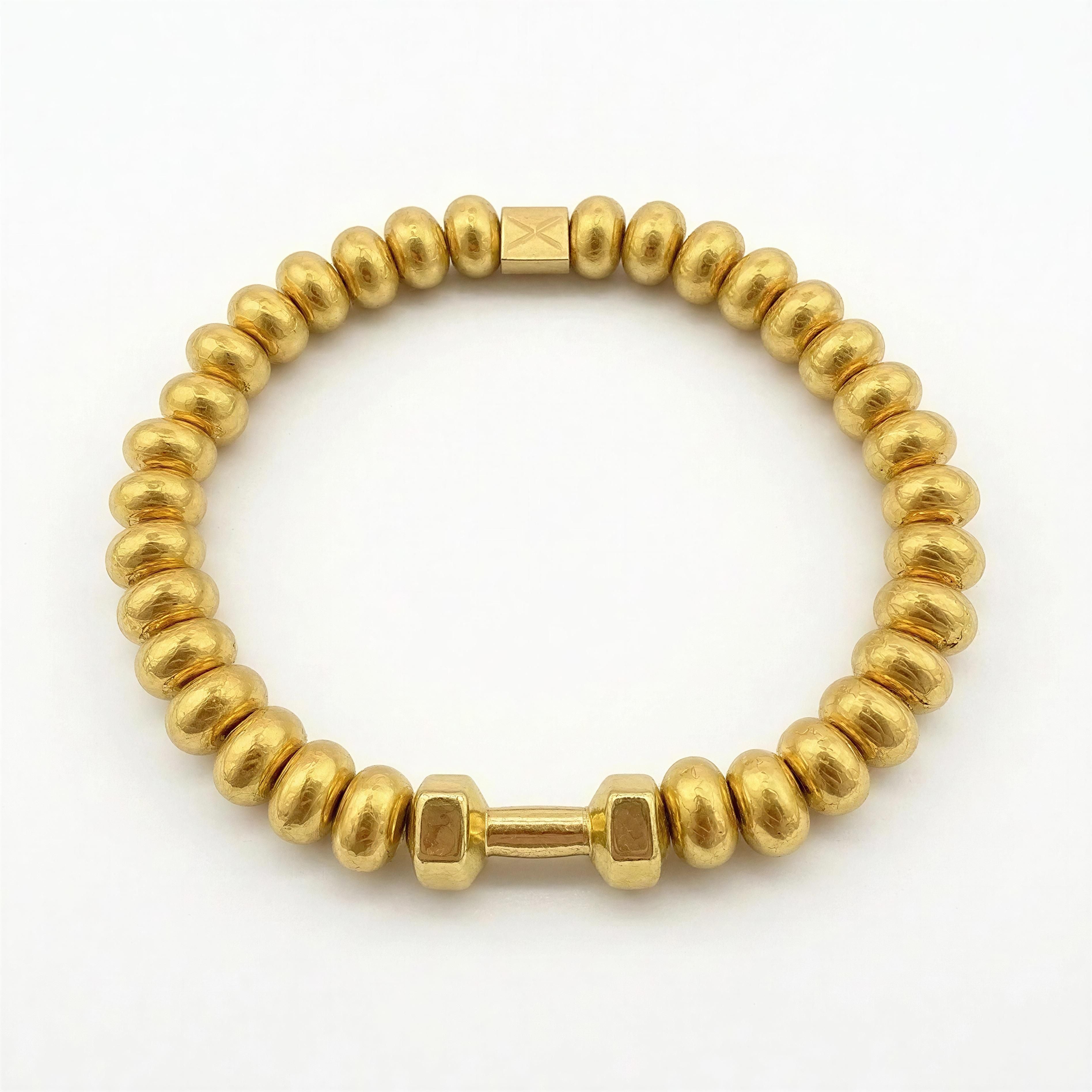 THE X FOR HIM - Golden Strength designer bracelet featuring handcrafted gold beads and a small dumbbell charm, embodying luxury and bold masculinity.