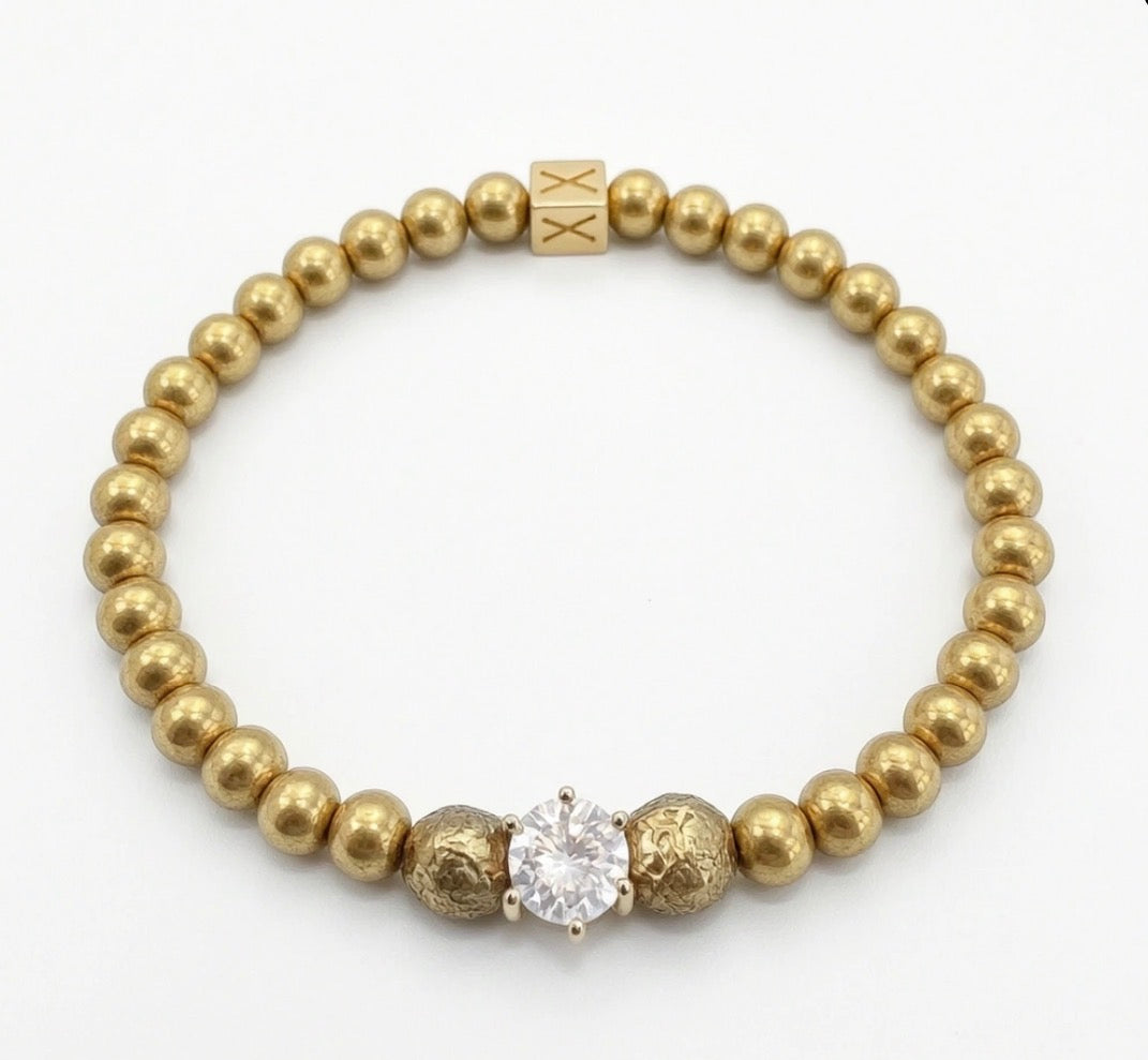 Timeless Collection - Lux Textura gold beaded bracelet with textured accents and a central sparkling clear stone, showcasing elegant handcrafted luxury jewelry design.