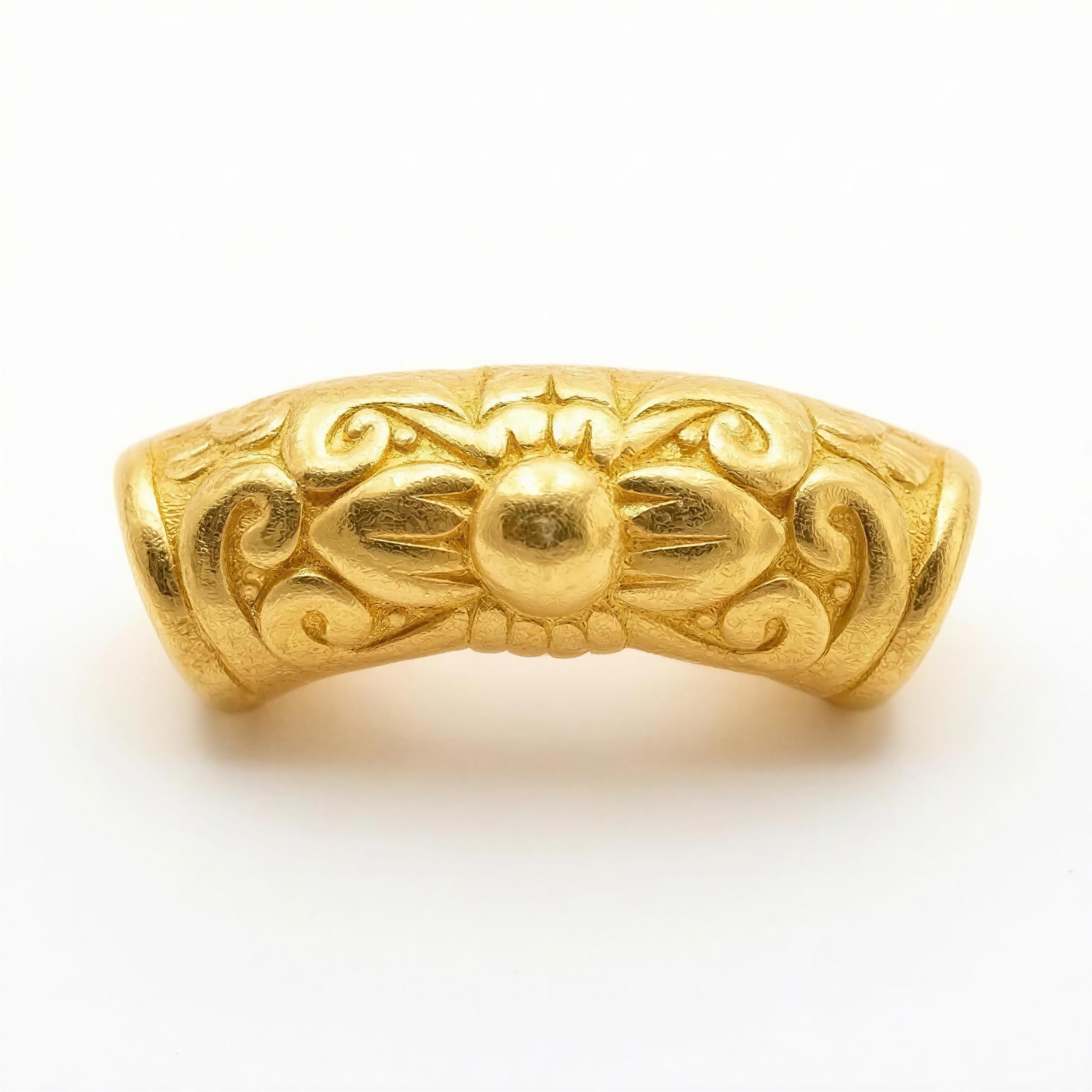 Intricately designed gold bead with floral and scroll motifs, representing luxury handcrafted details for Necklaces - AURELIS.