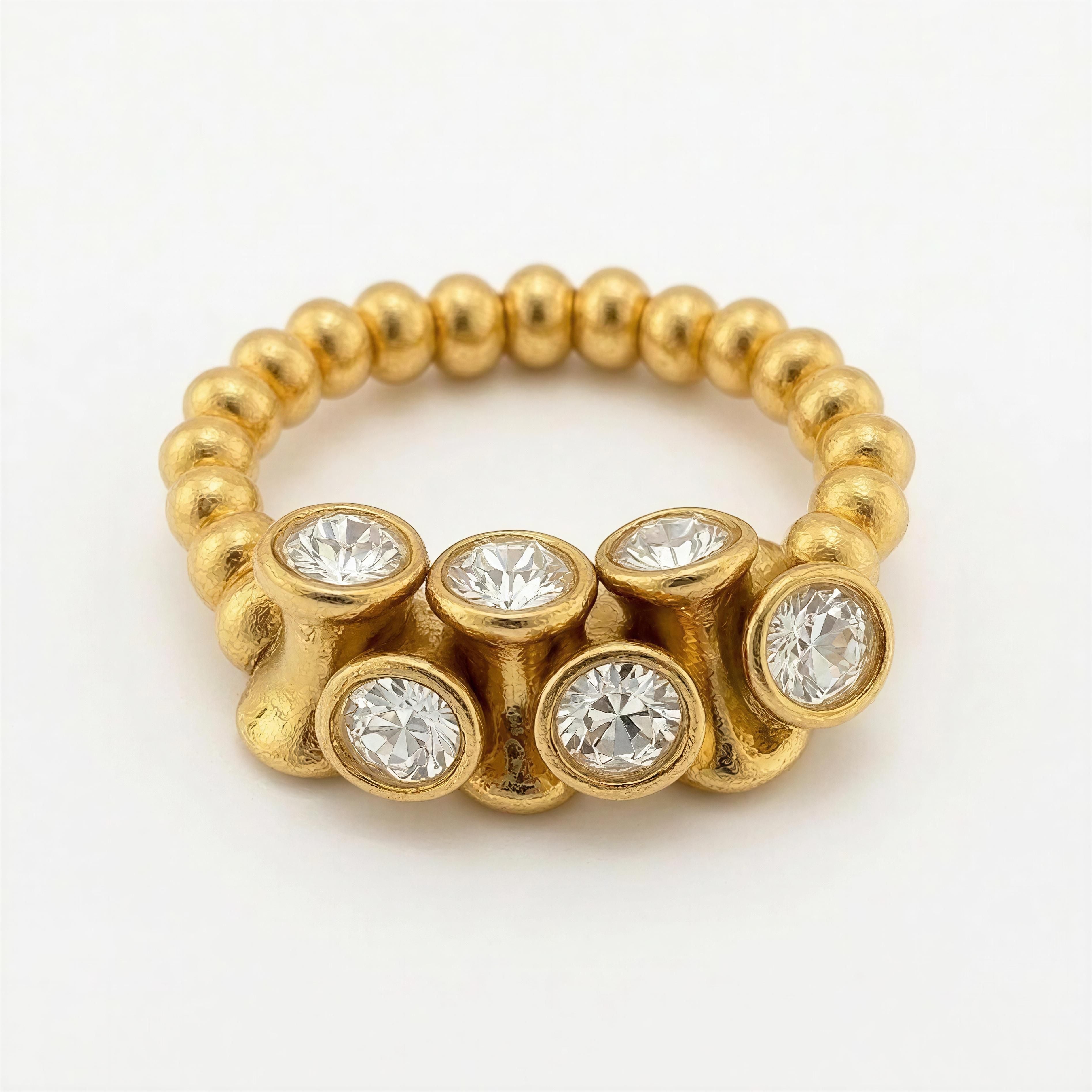 RING Golden Light featuring a unique gold beaded band with seven sparkling clear gemstones set in raised, textured gold settings, embodying handcrafted luxury jewelry.